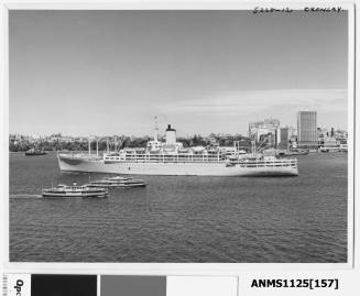 P&O liner ORONSAY departing Sydney with a warship moored at the entrance to Farm Cove seen just off the liner's starboard bow