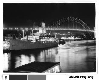 P&O liner ORONSAY moored at Circular Quay with landmarks such as the Sydney Harbour Bridge and Lunar Park visible