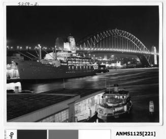 Evening view of P&O liner ORSOVA at Sydney Cove with the Sydney Harbour Bridge and Luna Park seen in the background