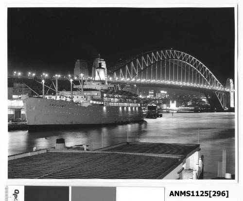 Night time view of P&O liner ORCADES moored at Circular Quay with the Sydney Harbour Bridge and Luna Park seen illuminated in the background