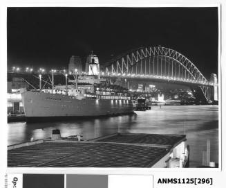 Night time view of P&O liner ORCADES moored at Circular Quay with the Sydney Harbour Bridge and Luna Park seen illuminated in the background