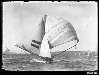 This image captures an 18-foot skiff believed to be the HC PRESS II under spinnaker