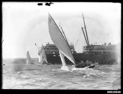 Three 21-foot restricted class yachts racing near a liner on Sydney Harbour