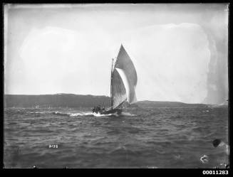 18-footer ROSETTA  sitting low in water on a very choppy water in Sydney Harbour