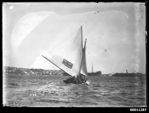 18-foot skiff AUSTRALIA heads into Rose Bay with freighter at anchor and spectator ferry in distance