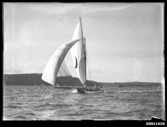 18-foot skiff with a crescent moon emblem sailing near Georges Heights, Sydney Harbour