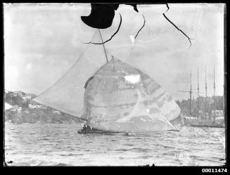 18-foot skiff with horseshoe or magnet sail insignia under a huge cloud of sail on Sydney Harbour