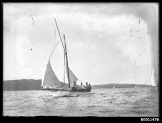 White clinker built gaff rigged yacht on Sydney Harbour