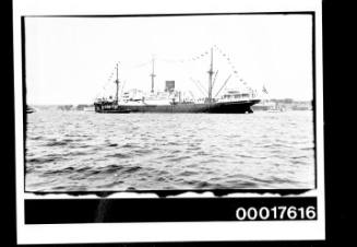 Untitled (Cargo vessel guided by tugboat)