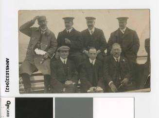 Postcard featuring a black and white photograph of seven men sitting in two rows, including three sea captains in uniform