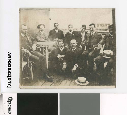 A group of men, with those in the front crouching, and those in the back sitting