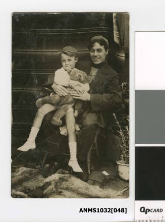 Photographic postcard of a man (possibly Charles Kerr) a young boy and a teddy bear