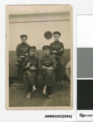 Postcard featuring a black and white photograph of four young men in sailor uniforms, one holding a cat