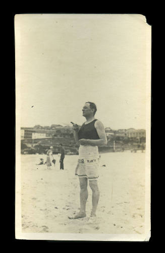 Bather on the beach wearing a Bondi towel