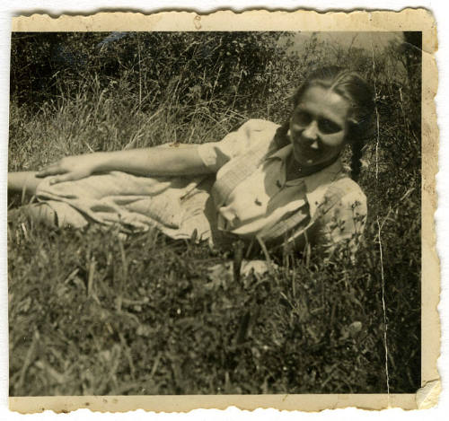 Young girl lying on grass, Lithuanian migrant