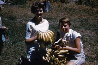 Ilsa and Eve Konrads with a bunch of bananas