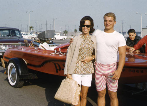 Couple next to a speedboat on trailer