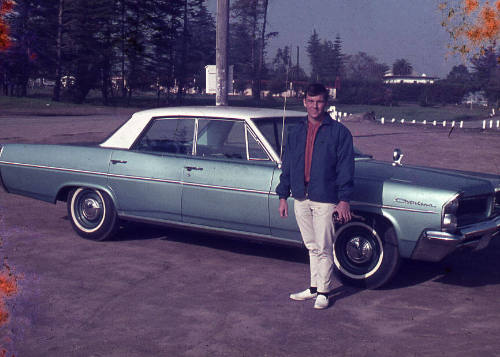 Bob Baker next to a car