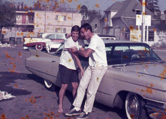 Two men next to a car