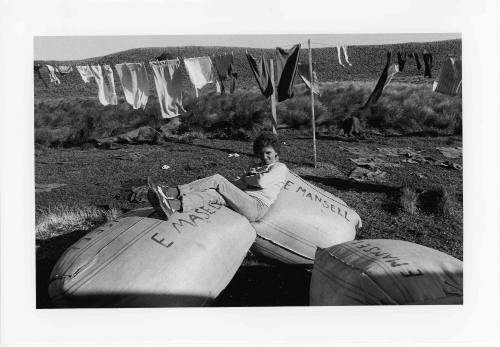 Untitled (Beryl Green sitting on sacks of feathers)