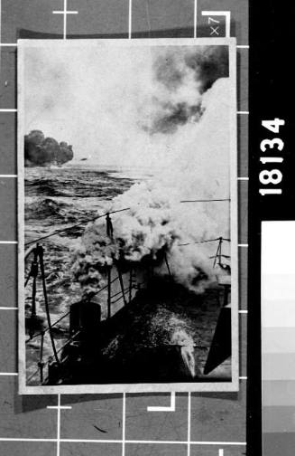Naval ships discharging smoke screens