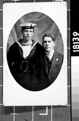 Portrait of Joseph Roy McCarthy in his HMAS AUSTRALIA (I) naval uniform standing beside his father or brother
