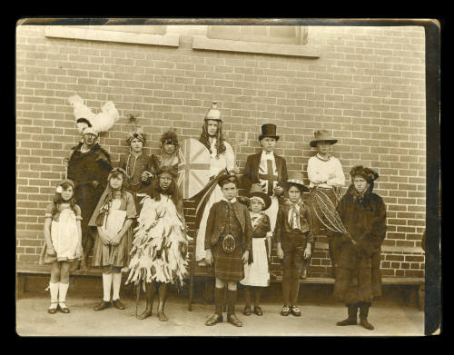 A group of children dressed in fancy costume (Note this image contains offensive depictions of First Peoples and may cause trauma for people whose identities are directly impacted)