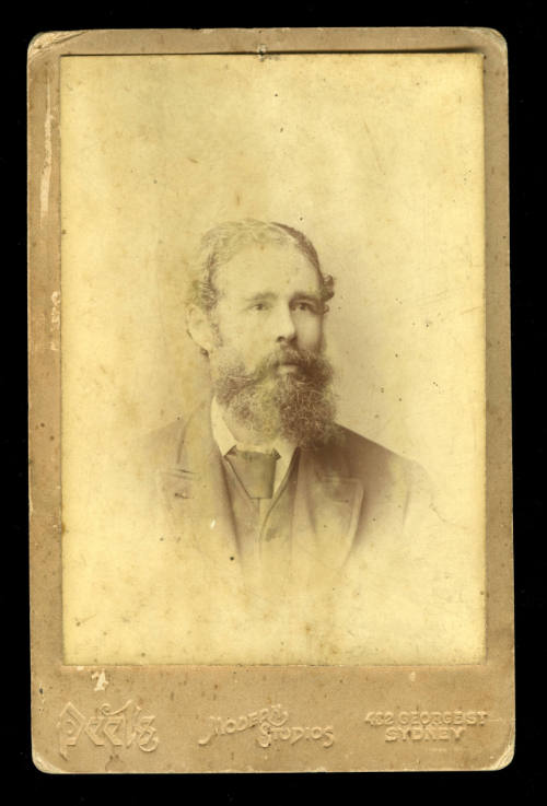 Man with a bushy beard, and wearing a waistcoat, jacket and tie