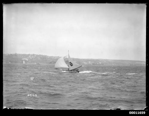 18-foot skiff MISSISSIPPI under main and headsail sailing on Sydney Harbour, lee clothes on for heavy weather