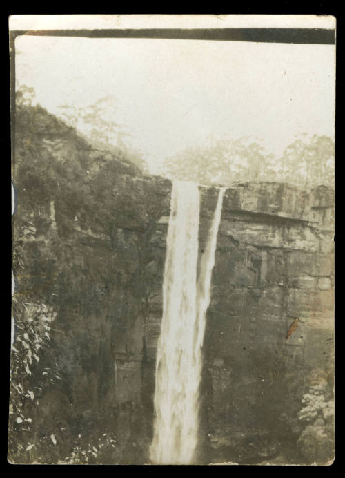 Waterfall cascading over a rock wall