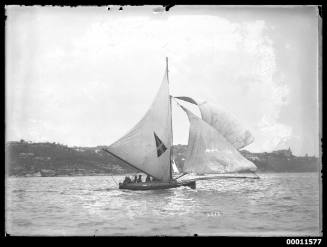 18-foot skiff with pennant insignia racing on Sydney Harbour