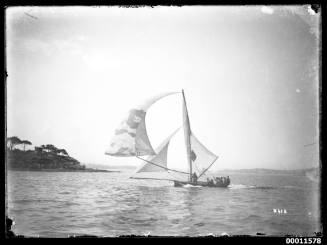 18-foot skiff with ballooning spinnaker on bending pole racing on Sydney Harbour