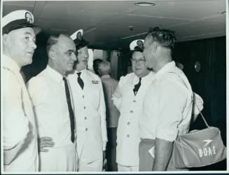 P&O Line public relations photograph showing Mr Alec Bedser, Assistant to the Manager for the MCC cricket team, talking with ship's officers of the P&O Orient liner CANBERRA
