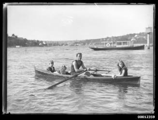 Family in a rowing boat with dog