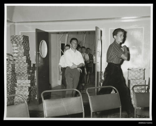 Group of young men entering a room