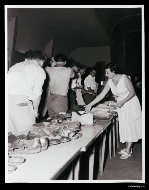 Group of young adult males at a clothin store at an Australian migrant centre