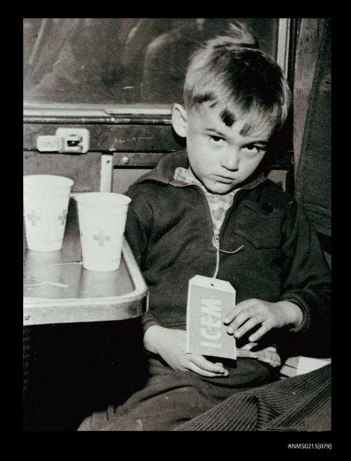 Yugoslavian boy in European train in transit to Australia as ICEM migrant