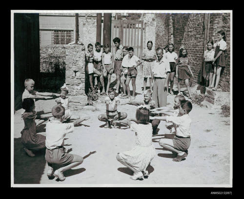 Young boys and girls doing supervised exercises at European migrant transit camp