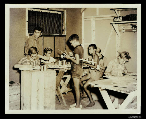 Boys working at benches during woodworking class