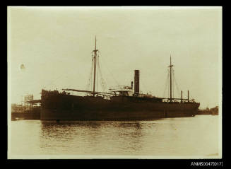 SS MONARO docked at a wharf beside a coal yard