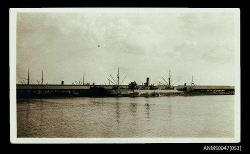 SS AUSTRALPORT docked at a wharf with warehouses visible in the background