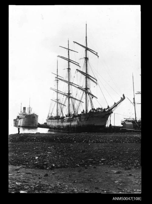 Full-rigged ship TALUS docked at a jetty