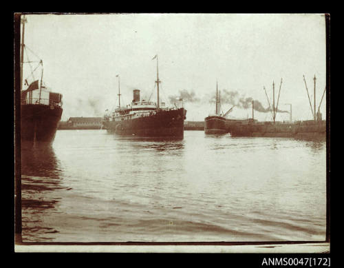 Steamship underway in a crowded harbour