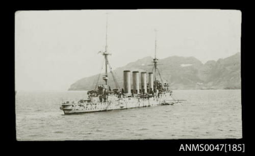 British cruiser, Devonshire Class, anchored offshore