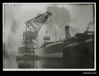 TITAN floating crane lowering a boiler into a steamship