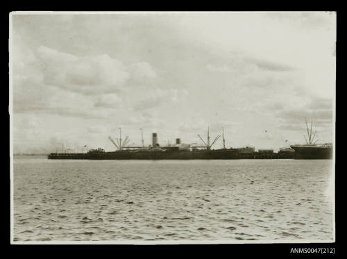 Steamship docked at a pier