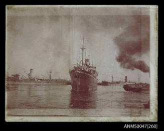 Steamship under tow in a harbour