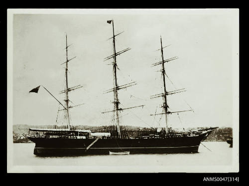 Full-rigged ship at anchor in a harbour