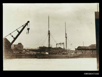 Schooner HAWK docked at a wharf, steam crane in foreground