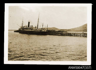 Jetty with a steamship docked at end of it